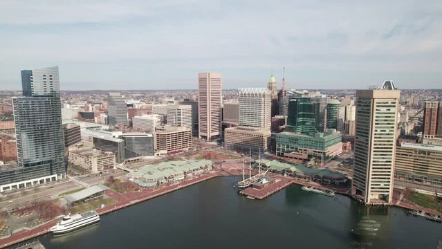 Very long drone pull-out shot of downtown Baltimore, inner harbor. 4K