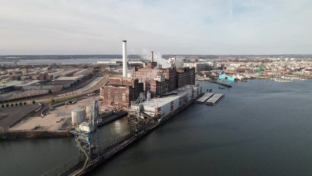 Panoramic aerial of Domino sugar factory in Baltimore, MD. Industrial manufacturing and shipping in the USA