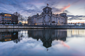 Sunset in Berlin. Government district with buildings. Reichstag in the evening. River Spree with...