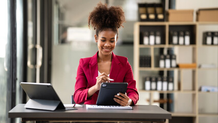 African american businesswoman in suit using tablet to reading a