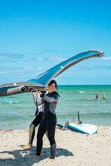 Girl in wetsuit learning wind foiling at Safety Bay in Perth, Western Australia