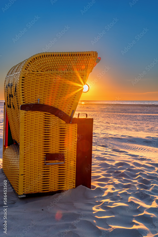 Wall mural beach chair at sunset on the beach on juist, east frisian islands, germany.