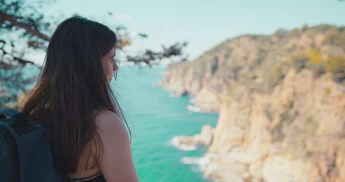 Girl looking at mountains and sea landscape