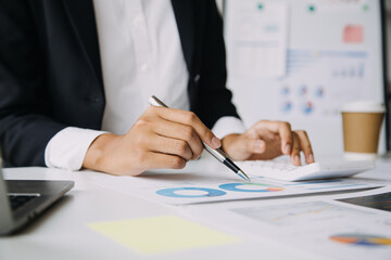 Financial analysts analyze business financial reports on a digital tablet planning investment project during a discussion at a meeting of corporate showing the results of their successful teamwork.