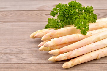 White asparagus and  bunch parsley on wooden table. Fresh vegetables. - 586454906