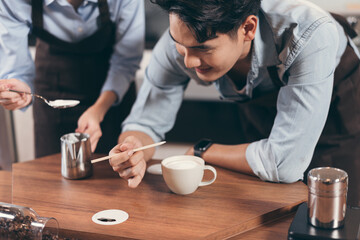 Obraz na płótnie Canvas Happy barista Asia man make coffee at coffee shop 