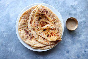 Puran Poli is an Indian sweet flatbread stuffed with chana dal, jaggery, ghee and cardamom and is...