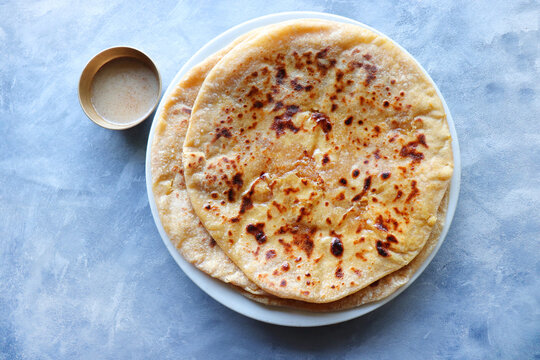 Puran Poli is an Indian sweet flatbread stuffed with chana dal, jaggery, ghee and cardamom and is usually eaten at Holi or Gudi Padva festival. Recipe ingredients. copy space. Healthy sweet dessert. 