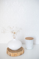 Fototapeta na wymiar Dry flowers in a white vase on a white background