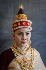 Pretty young Asian woman dressed elegantly in dress Luang Prabang Laos style for the Songkran Festival is the national tradition of Thailand and in Vientiane Laos at Chiang Mai Thailand.
