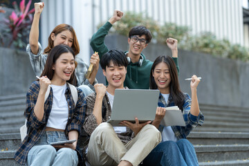 Group of happy multiethnic colleagues shaking hands Express joy in the creative team. Friends or students in project meetings at modern university startups or teamwork concepts.