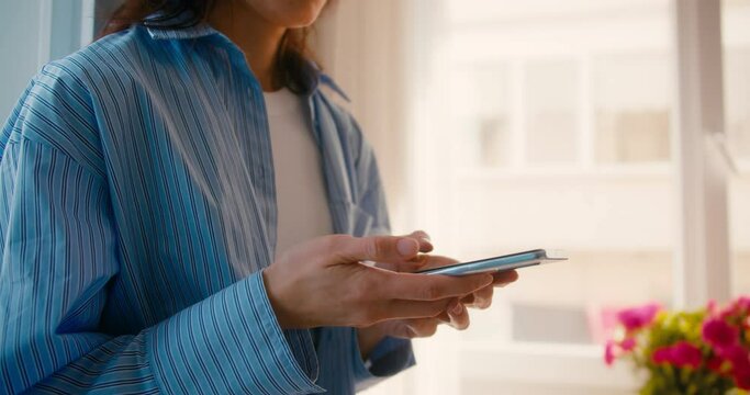 Woman hands texting, using smartphone at home, close-up shot