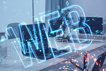 Close up of laptop computer at workplace with glowing linear web text hologram on blurry background. Digital nft, technology and future concept. Double exposure.