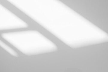 Gray shadow and light blur abstract background on white wall  from window.  Dark grey shadows indoor in room  background, monochrome, shadow overlay effect for backdrop and mockup design