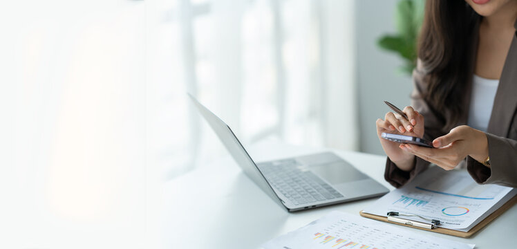 Copy space, Panorama, Banner, Businesswoman holding pen and dialing phone to make contact to client or investor on earnings report, financial income, real estate project in office.