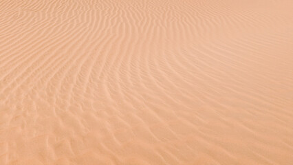 Sand dunes in the desert with a light on the top