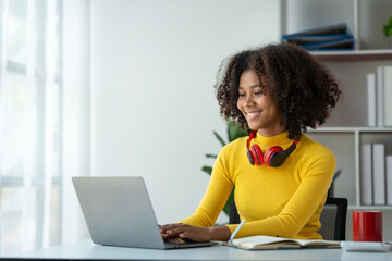 start-up business, young african woman american used laptop computer typing Search online for financial business information. Marketing from various applications at home office concept of living.