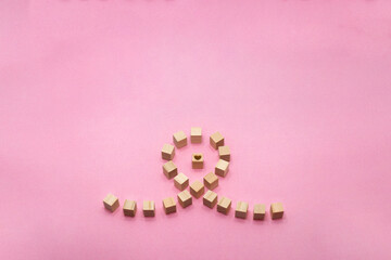 ハートを丸く囲むように広がる立体的なウッドキューブの紐のピンクの背景