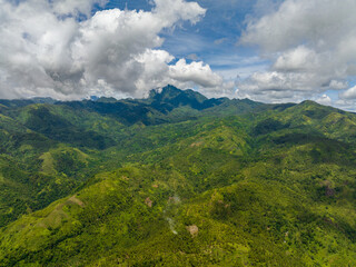Naklejka premium Tropical mountain range and mountain slopes with rainforest. Philippines, Negros island.