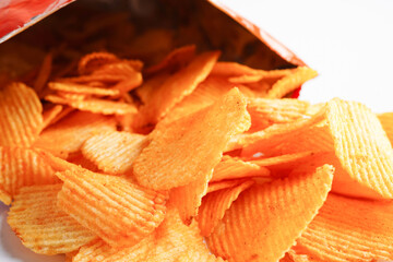 Potato chips in open bag, delicious BBQ seasoning spicy for crips, thin slice deep fried snack fast food in open bag.