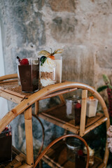 Obraz premium Serving trolly filled with glasses of cream and fruits