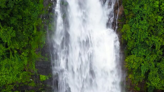 A beautiful waterfall in the mountains among the jungle. Mapalana Falls. Sri Lanka.