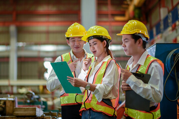 Factory apprenticeship. Header mentor teaching young employees trainee operating machine looking monitor and check Production process machinery. foreman explaining team engineer control machine