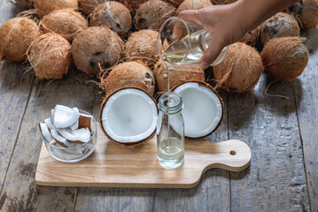 Virgin coconut oil liquid by cold pressed with HDL by Raw coconut milk in glass bottle.