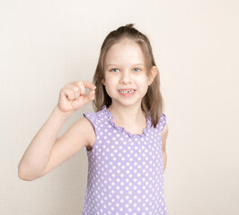 little girl 6-7 years old has lost milk tooth. Loss of milk teeth, have fun