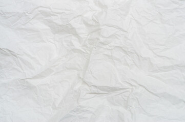Wrinkled or crumpled white stencil paper or tissue after use in toilet or restroom with large copy space used for background texture in decorative art work