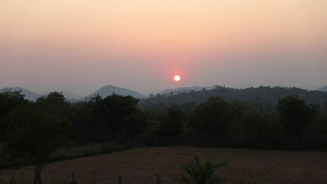 Timelapse of a beautiful sunset. Aerial view. Set against the backdrop of rolling hills and mountains. 