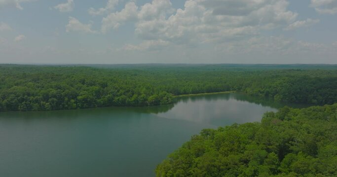 Aerial Panning Beautiful Shot Of Tranquil River And Forest Under Cloudy Sky - Tuscaloosa, Alabama