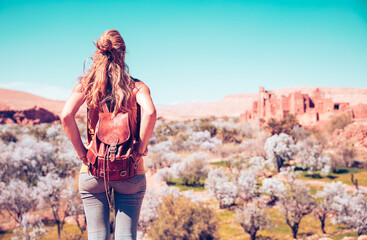 Naklejka premium Woman looking at panoramic view of moroccan countryside landscape in ben haddou near Ouarzazate