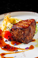 Grilled beef steak filet mignon with potato and sauce in plate