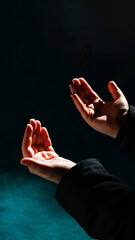 Islamic background photo. Muslim man praying with raising hands.