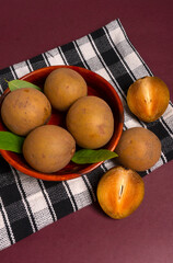 Sapodilla fruit (Manilkara zapota) and other names such as sapota, chikoo, chico, naseberry, or nispero. Sapodilla is tropical fruit evergreen tree and sweet taste fruit