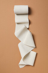 Help during an injury, elastic bandage on beige background