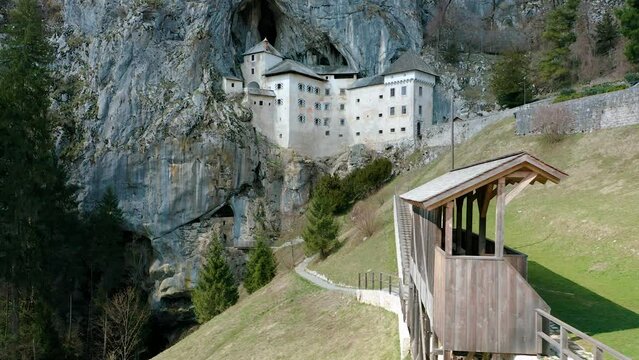 Orbit Around Most Fascinating, Historic Medieval Predjama Castle, Built Into Mouth Of a Cave, Under The Cliff. Popular Tourist Attraction With Knights Tournament Battlefield in Front of the Castle.