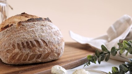 Artisan Batard Sourdough healthy Bread with leaf scoring. Open crumb high hydration Sourdough bread set on white table.