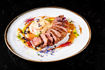 Roasted Duck breast fillets with vegetable pure in plate