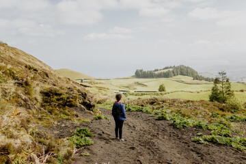 Rear view woman contemplating landscape in Azores island
