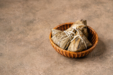 Zongzi is a traditional Chinese food made of glutinous rice stuffed with different fillings and...