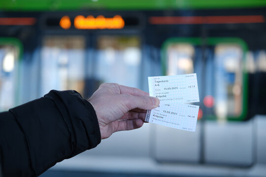 passenger, male hands hold tickets, travel passes for public transport, Hannover Stadtbahn train, typical German Public Transport Stadtbahn travels platform, Hannover, Germany - March 2023