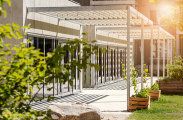 Canopy Awning on Entrance Building. Aluminum Pergola Garden by Modern House with Glass Facade...