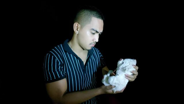 handsome young filipino man with teddy bear
