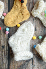 Various styles handmade baby socks, on dark wooden background