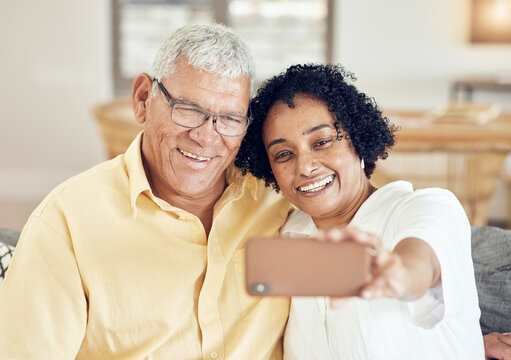 Senior couple, smile and selfie in home with love, bonding and hug for support, relax and peace on blog app. Elderly man, old woman and social media for profile picture with tech in living room