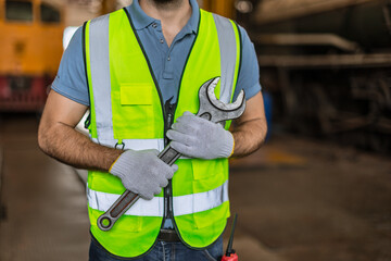 closeup male worker hand holding big wrench for fix service strong team