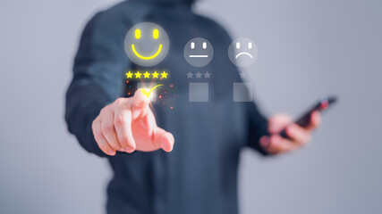 Man touching the virtual screen on the happy smiley face icon and five star to assessment satisfaction in service. Rating very impressed. Customer service, testimonial and satisfaction concept..