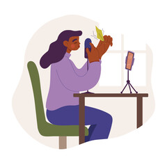 Girl or young woman sits at desk in front of smartphone and records the whispering and rustling of paper on microphone. Recording sounds and voices for ASMR content, podcast or blog.